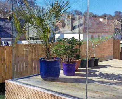 Solus frameless glass balustrade fitted to a wood decking in Cornwall