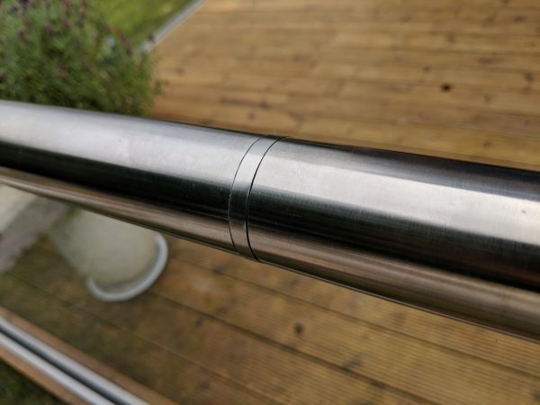 Slotted handrail connector for use on frameless glass balustrades