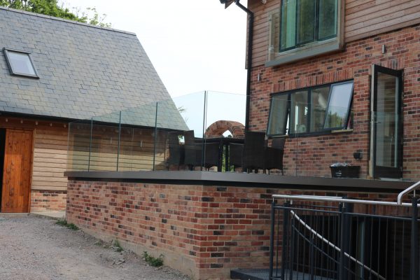 Vantage Balustrades Solus system installed on a patio for frameless glass balcony